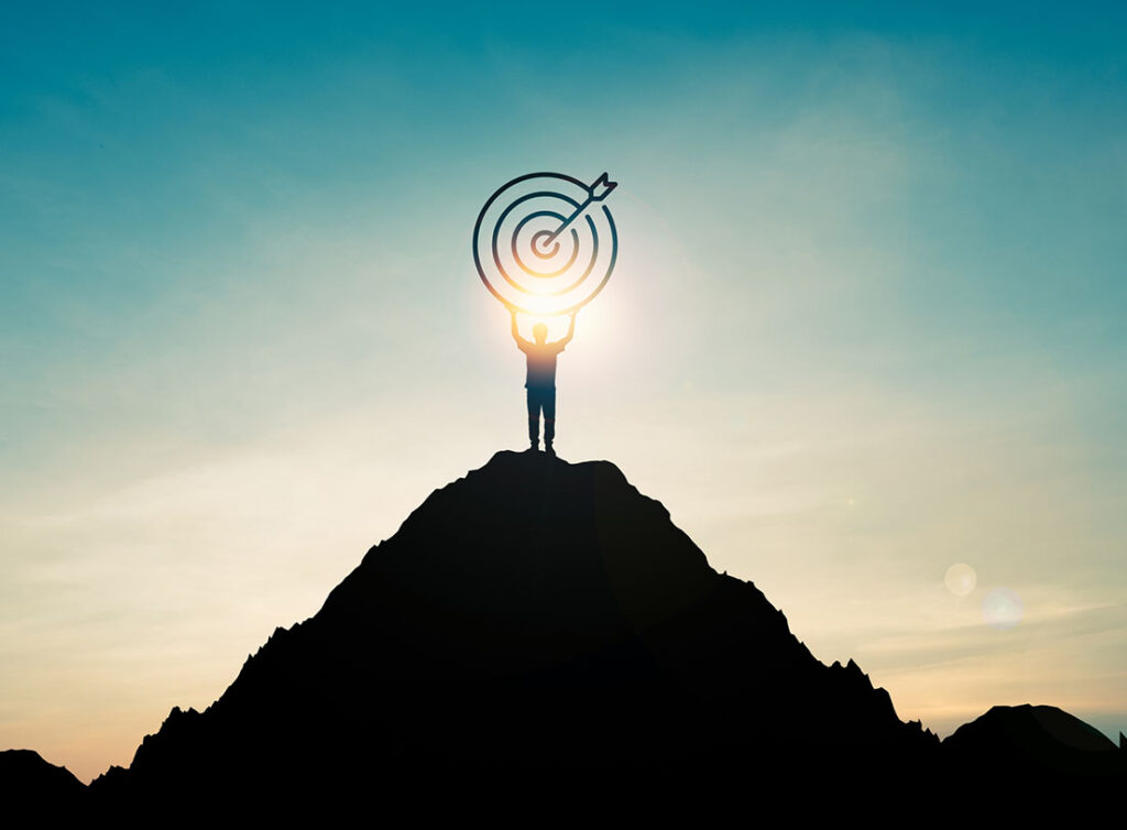 man on a hill holding a target